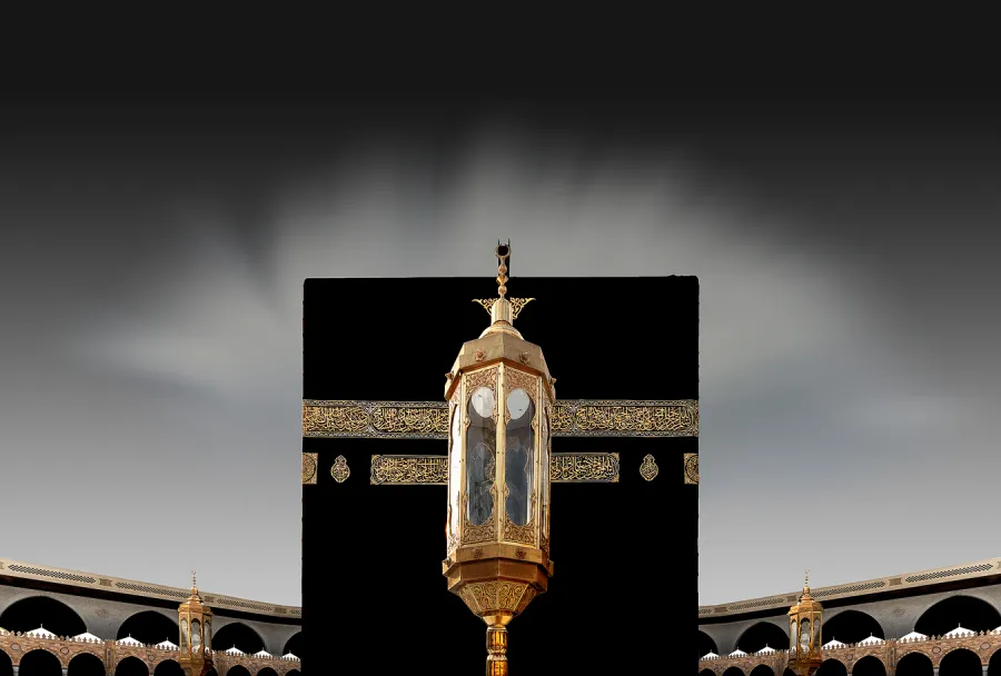 The gilded Maqam Ibrahim enclosure centered against the Kaaba's Kiswah