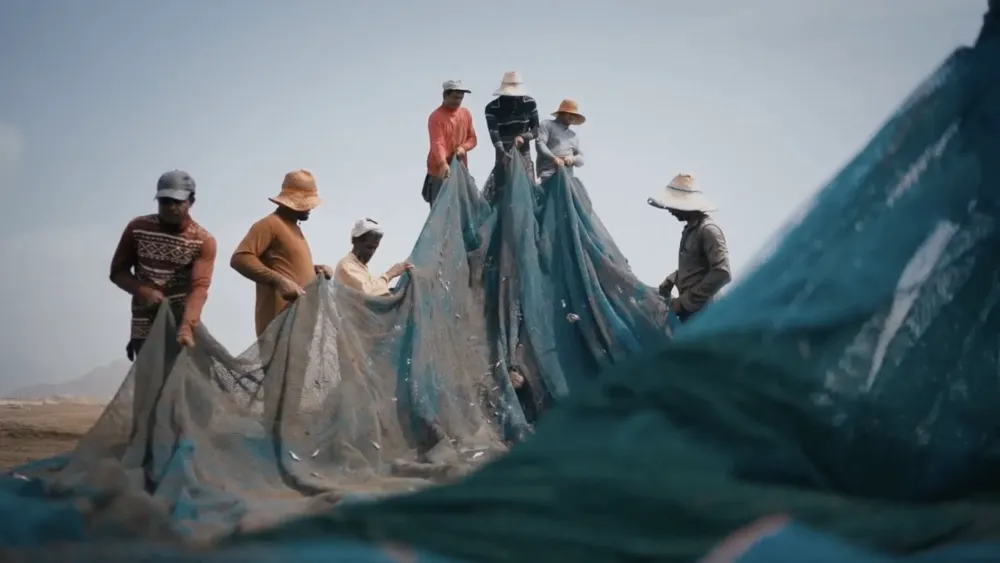 Close portrait of a fisherman inside a coastal transport van, still from UMAH